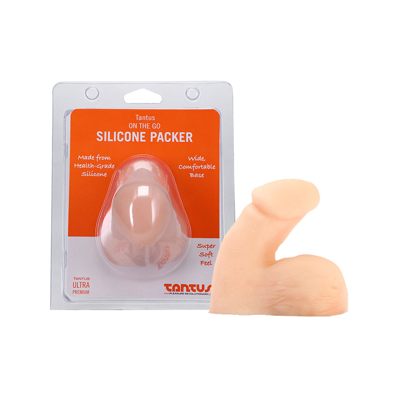 Tantus On The Go Silicone Packer Cream (Clamshell) cream-colored Tantus On The Go packer beside its clear orange-label clamshell