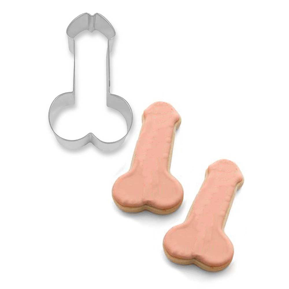 Glitterati Penis Cookie Cutter silver penis-shaped cookie cutter beside two pink iced cookies