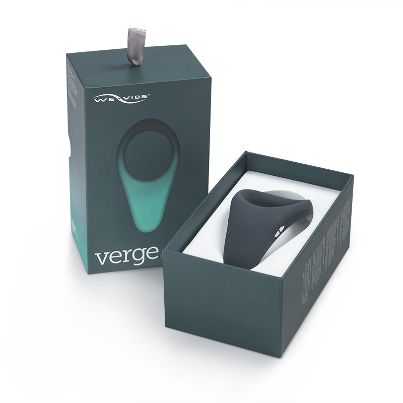 We-Vibe Verge Rechargeable Vibrating Perineum Stimulator Cockring Slate We-Vibe Verge Slate cock ring curved matte ring nested in an open dark teal box with charging tab visible