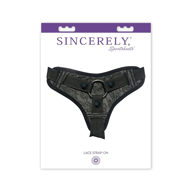 Sincerely, Sportsheets Lace Adjustable Strap-On Harness Black Sportsheets Sincerely black strap-on harness inside white-and-purple retail card