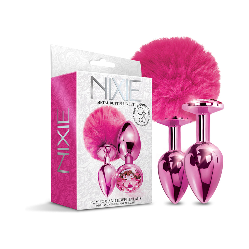 NIXIE Metal Butt Plug Set Pom Pom and Jewel-Inlaid Metallic Pink Metallic pink NIXIE pom pom and jewel plugs beside white box
