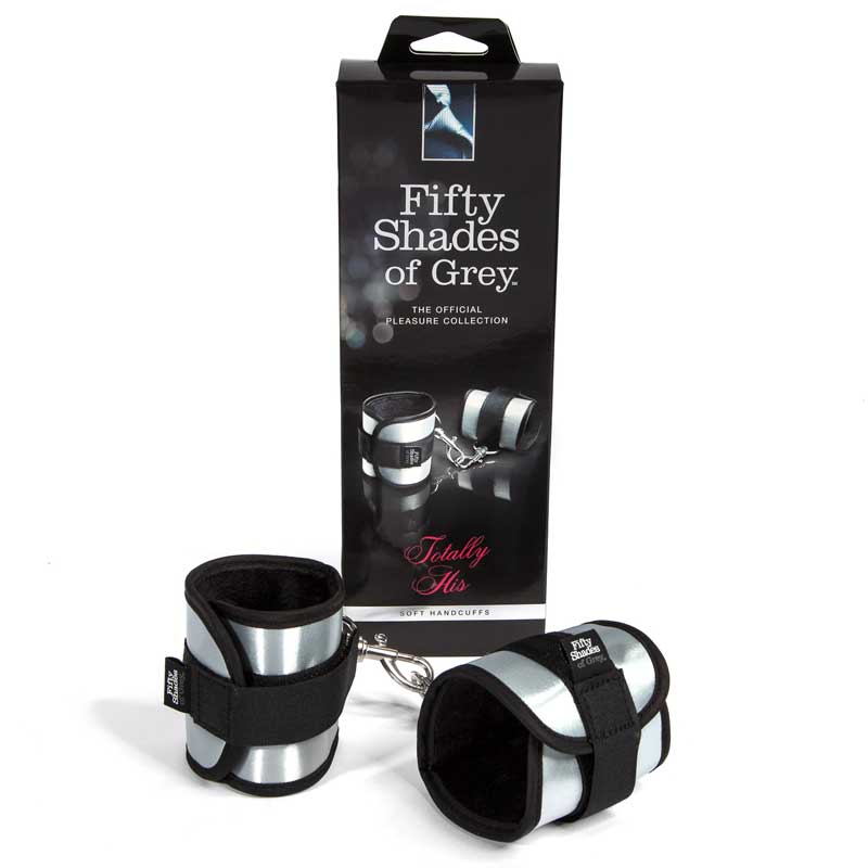 Fifty Shades of Grey Totally His Soft Velcro Handcuffs Silver Fifty Shades Totally His Cuffs silver and black cuffs beside tall retail box
