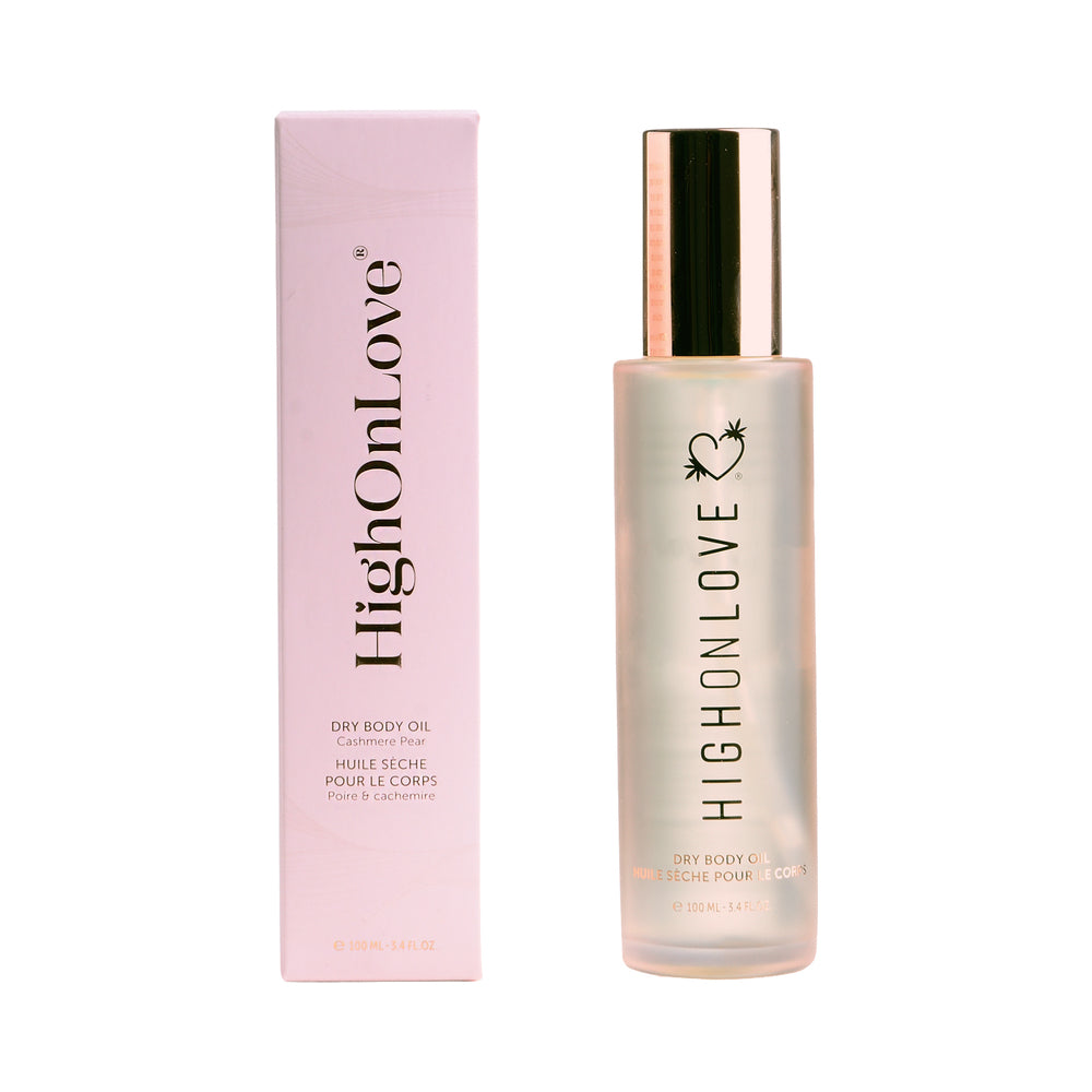 HighOnLove Cashmere Pear Dry Body Oil 3.4 oz. HighOnLove Cashmere Pear dry body oil 3.4 oz clear bottle with gold cap beside the matching pink box