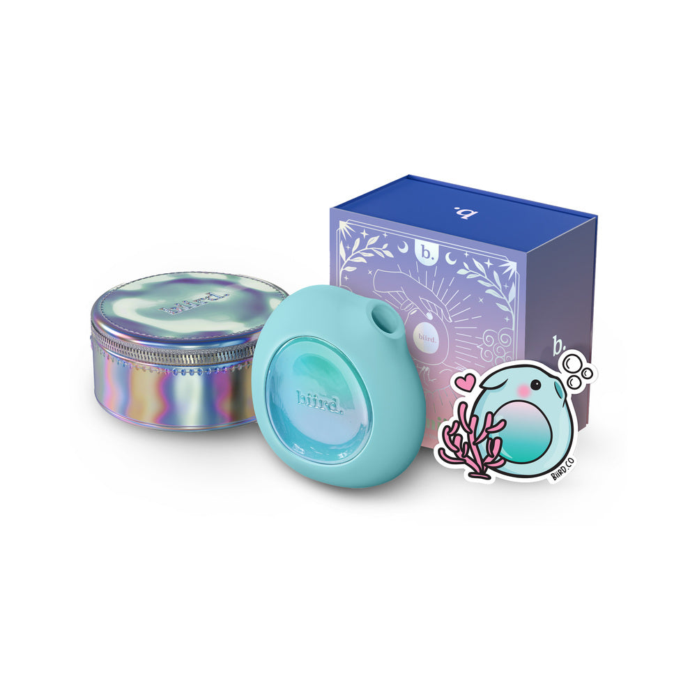 Biird Lumii Clitoral Suction Stimulator Mint Biird Lumii mint suction stimulator beside iridescent pouch box and sticker