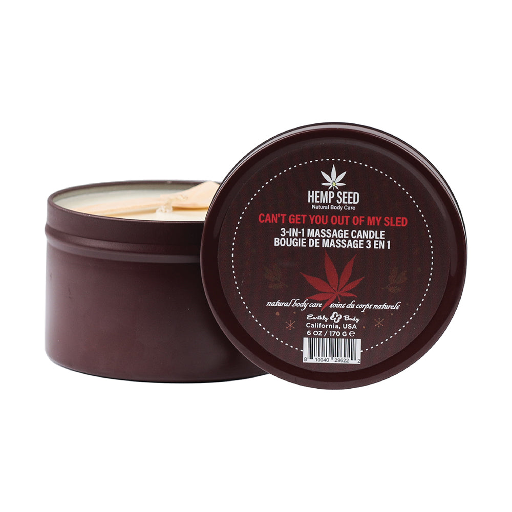Earthly Body Hemp Seed 3-in-1 Holiday Candle Can''t Get You Out Of My Sled 6 oz. open brown Earthly Body Hemp Seed candle tin beside printed lid