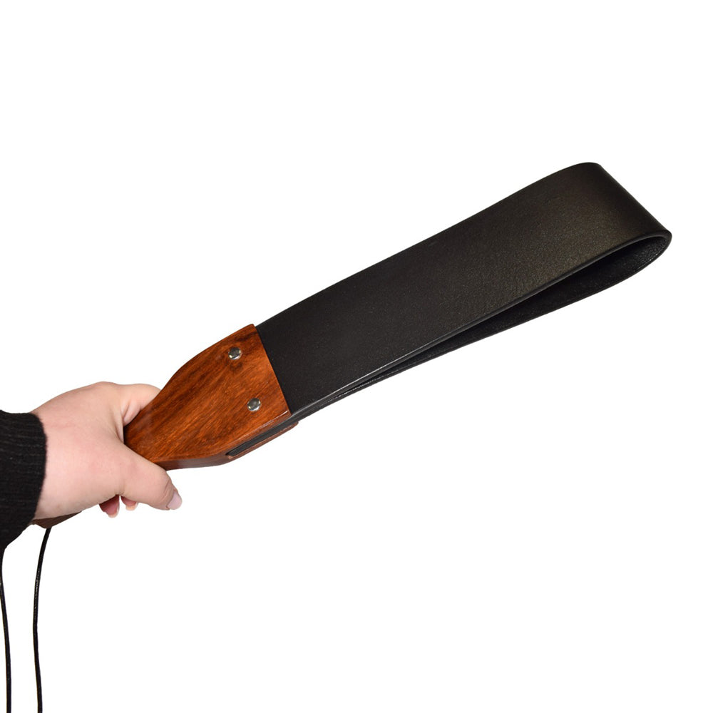 Prowler RED Leather and Wood Flapper Paddle Hand holding Prowler RED black leather flapper paddle