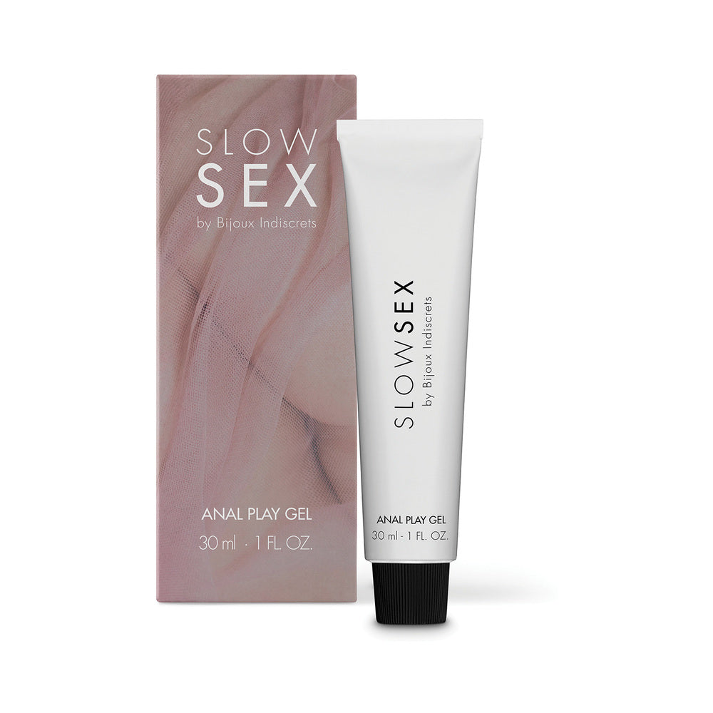 Bijoux Indiscrets Slow Sex Anal Play Gel 1 oz. white Slow Sex Anal Play Gel tube with black cap beside blush-colored carton