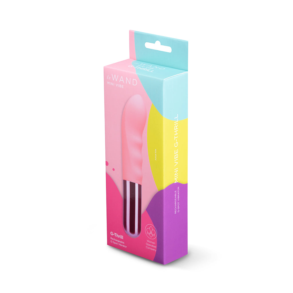 Le Wand Mini Vibe G-Thrill Light pink Le Wand G-Thrill beside pink-and-teal retail box