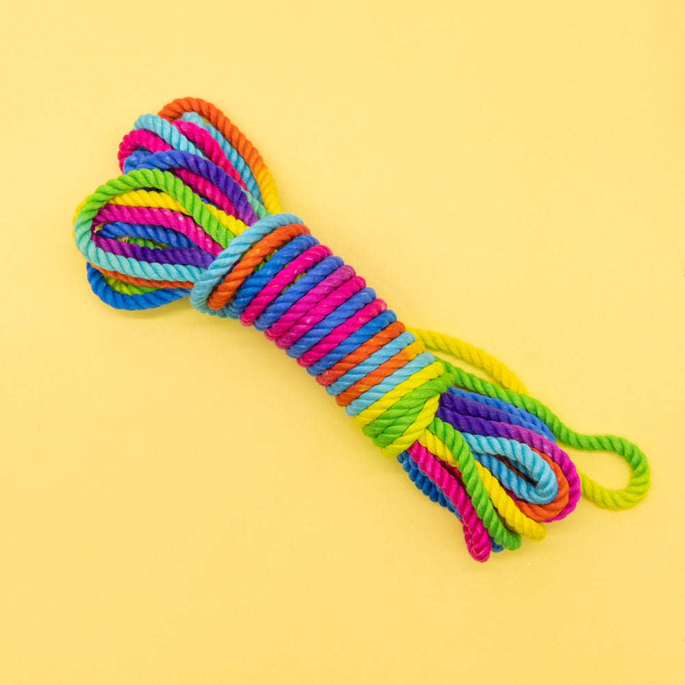 Emojibator Unicorn Rainbow Bondage Rope 26.25 '' coiled rainbow bamboo-silk rope with multicolor strands on yellow background