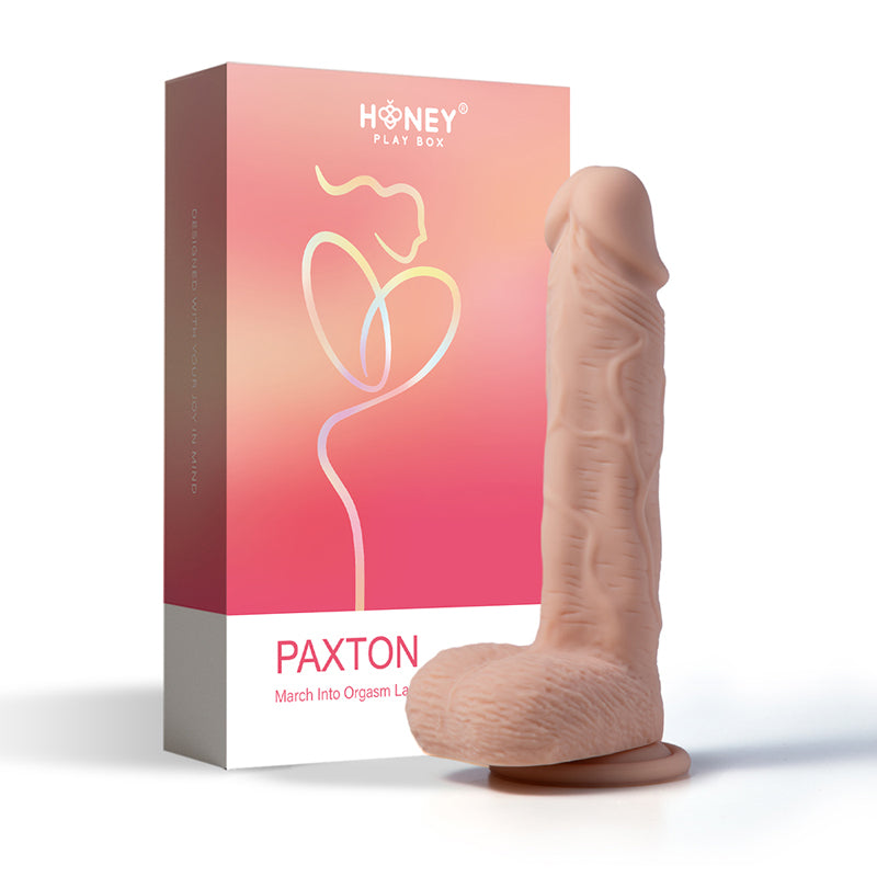 Honey Play Box Paxton App Controlled Realistic Thrusting Penetrator Dildo 7.5 in. Honey Play Box Paxton beige textured dildo with circular base beside coral box