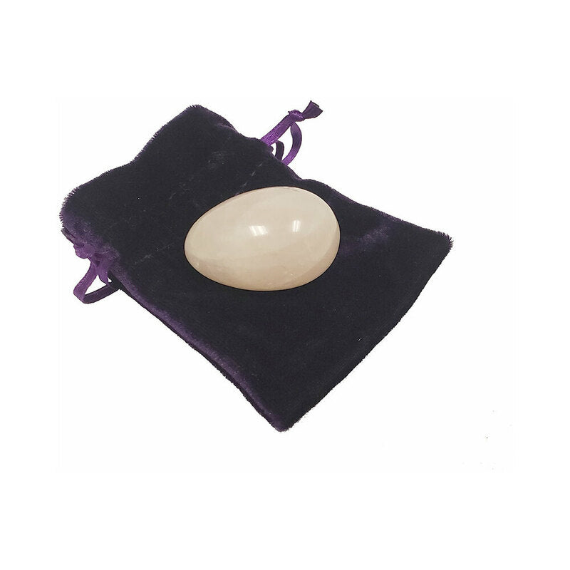 Crystal Egg Kegel Massager pale egg-shaped Kegel massager resting on dark purple drawstring pouch