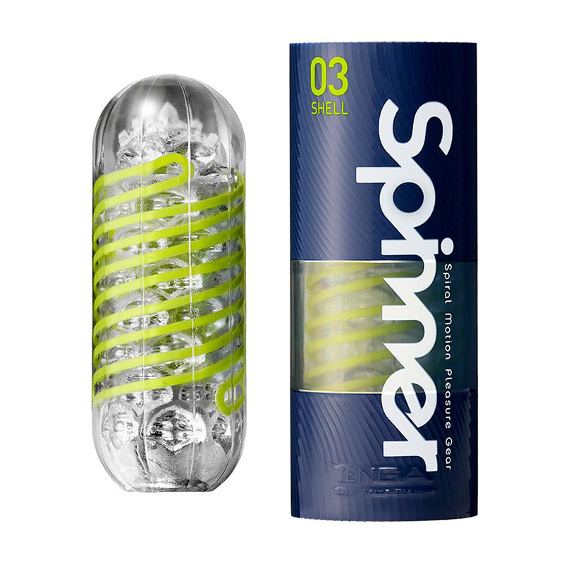 Tenga Spinner 03 Shell clear capsule with lime spiral ribs beside navy-and-lime cylindrical carton