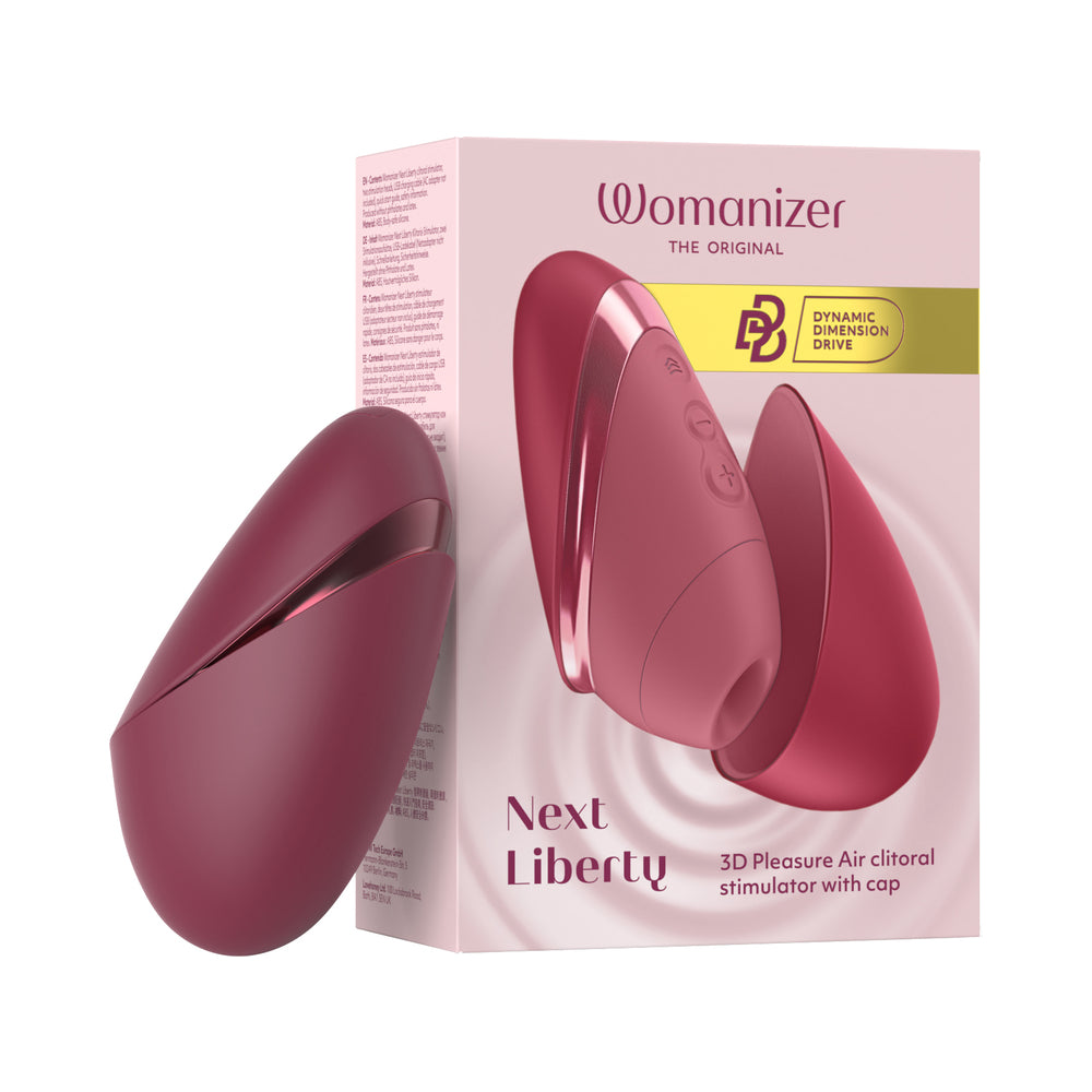 Womanizer Next Liberty Bordeaux Womanizer Next Liberty Bordeaux clitoral stimulator with protective cover beside the pink retail box