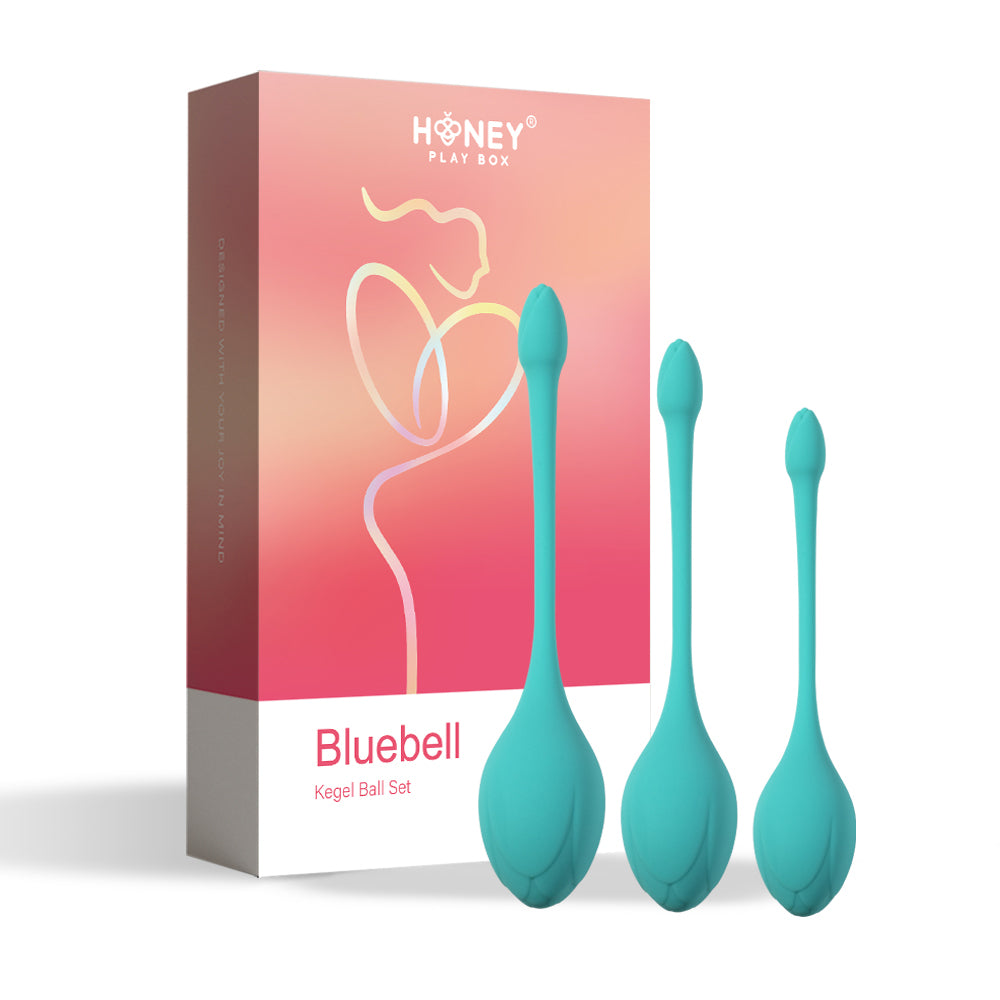 Honey Play Box Bluebell Floral Weighted Kegel Ball 3-Piece Set three teal Bluebell weighted Kegel balls in graduated sizes beside coral box