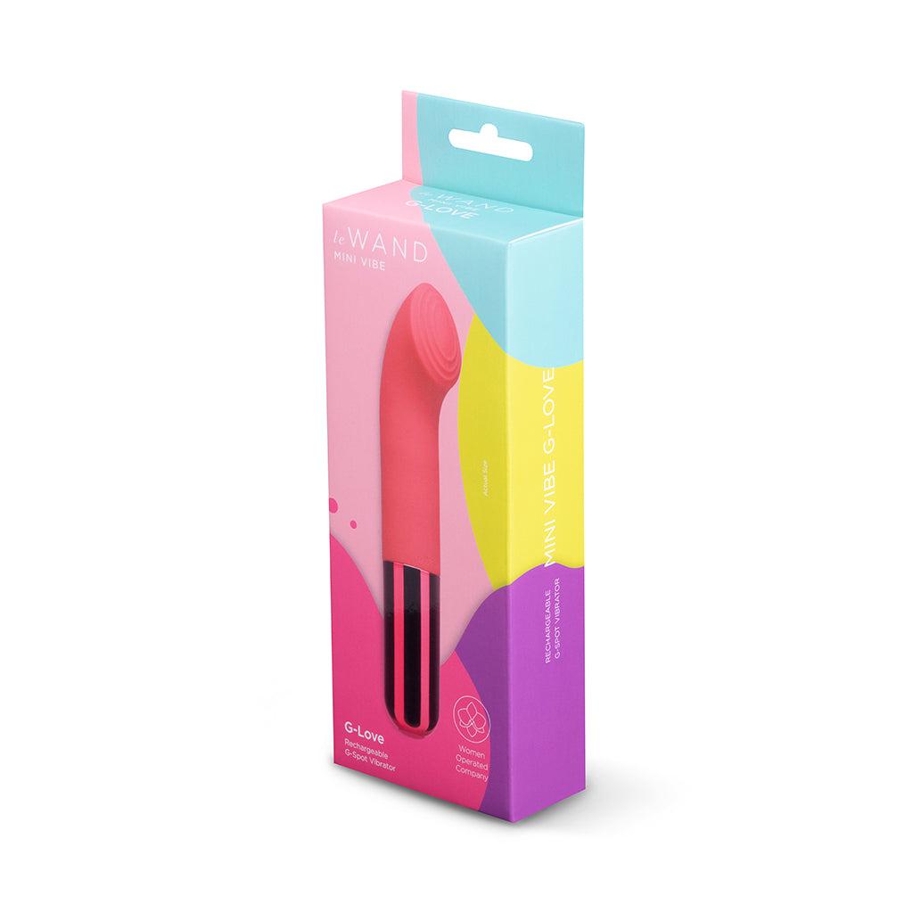 Le Wand Mini Vibe G-Love Hot pink Le Wand G-Love beside pink-and-teal retail box