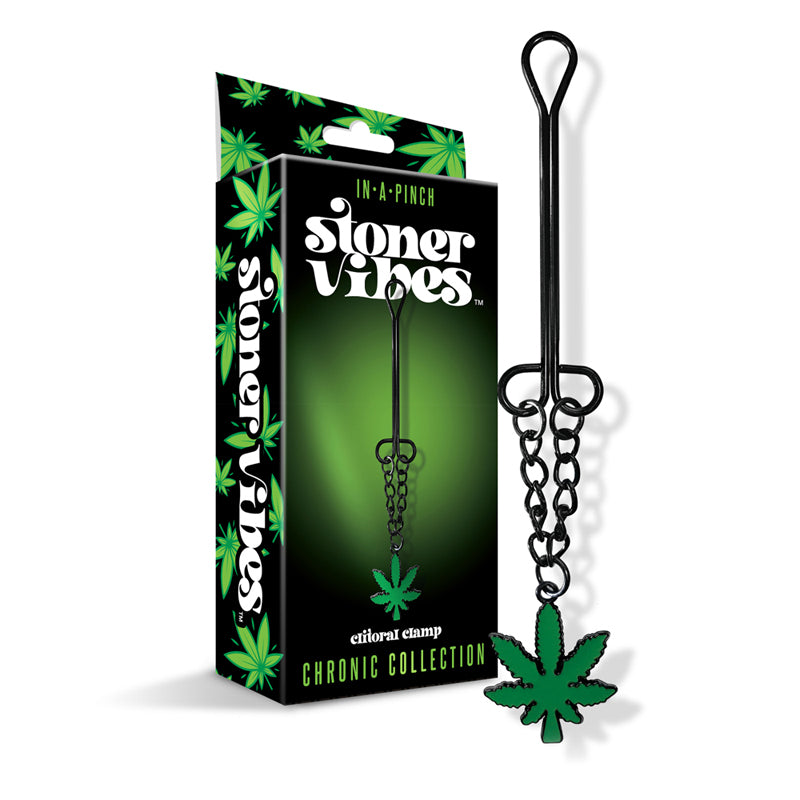 Stoner Vibes Chronic Collection Clitoral Clamp with Chain Stoner Vibes black metal clitoral clamp and green charm beside box