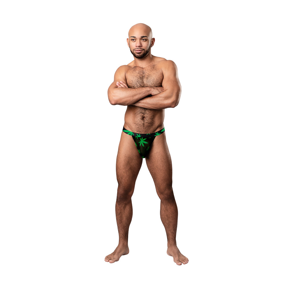 Male Power Hazy Dayz Micro Thong Pot Leaf S/M model wearing black micro thong with bright green pot-leaf print