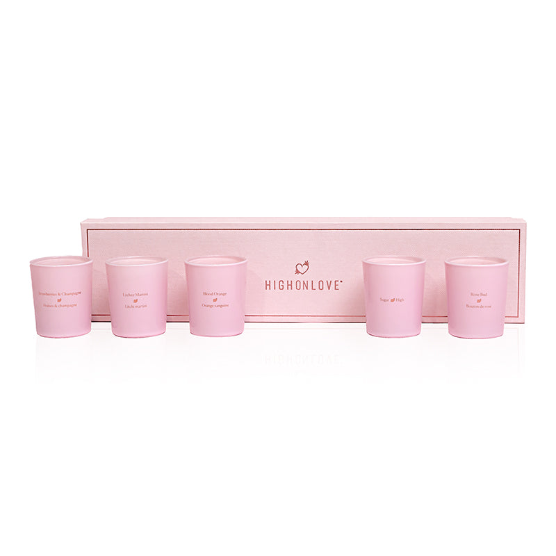 HighOnLove Mini Sensual Massage Candles Collection five pink HighOnLove mini massage candles arranged inside a long blush gift box