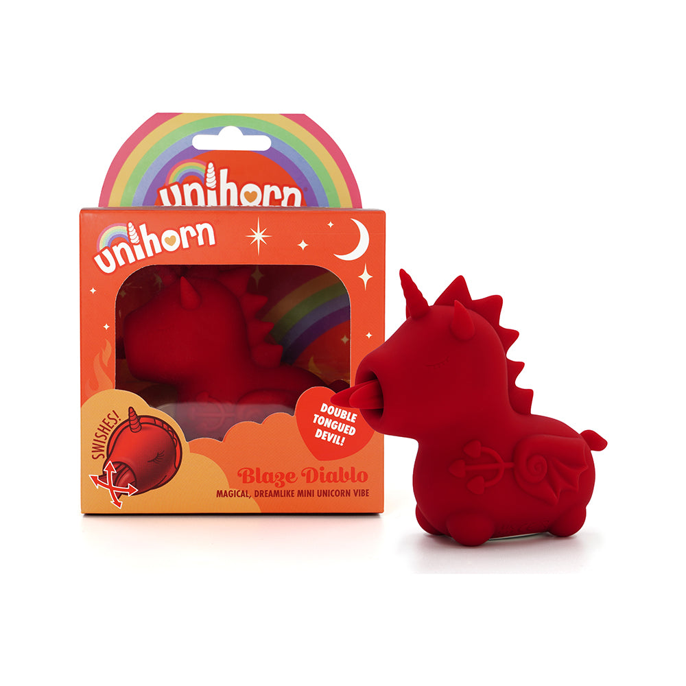 Unihorn Blaze Diablo (The Forked Tongue One) red Unihorn Blaze Diablo horned vibrator beside orange window box