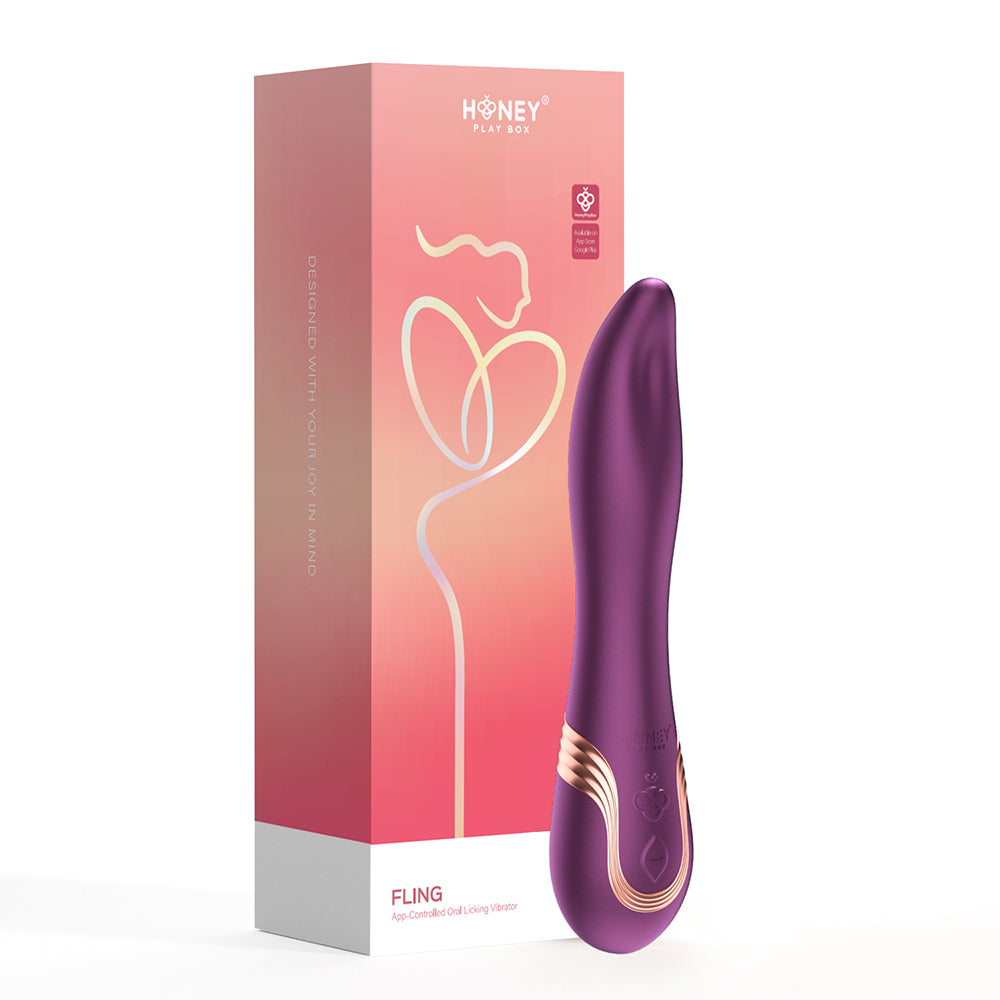 Honey Play Box Fling Tongue-Like Oral Licking Vibrator purple Honey Play Box Fling curved vibrator with gold accent beside coral box