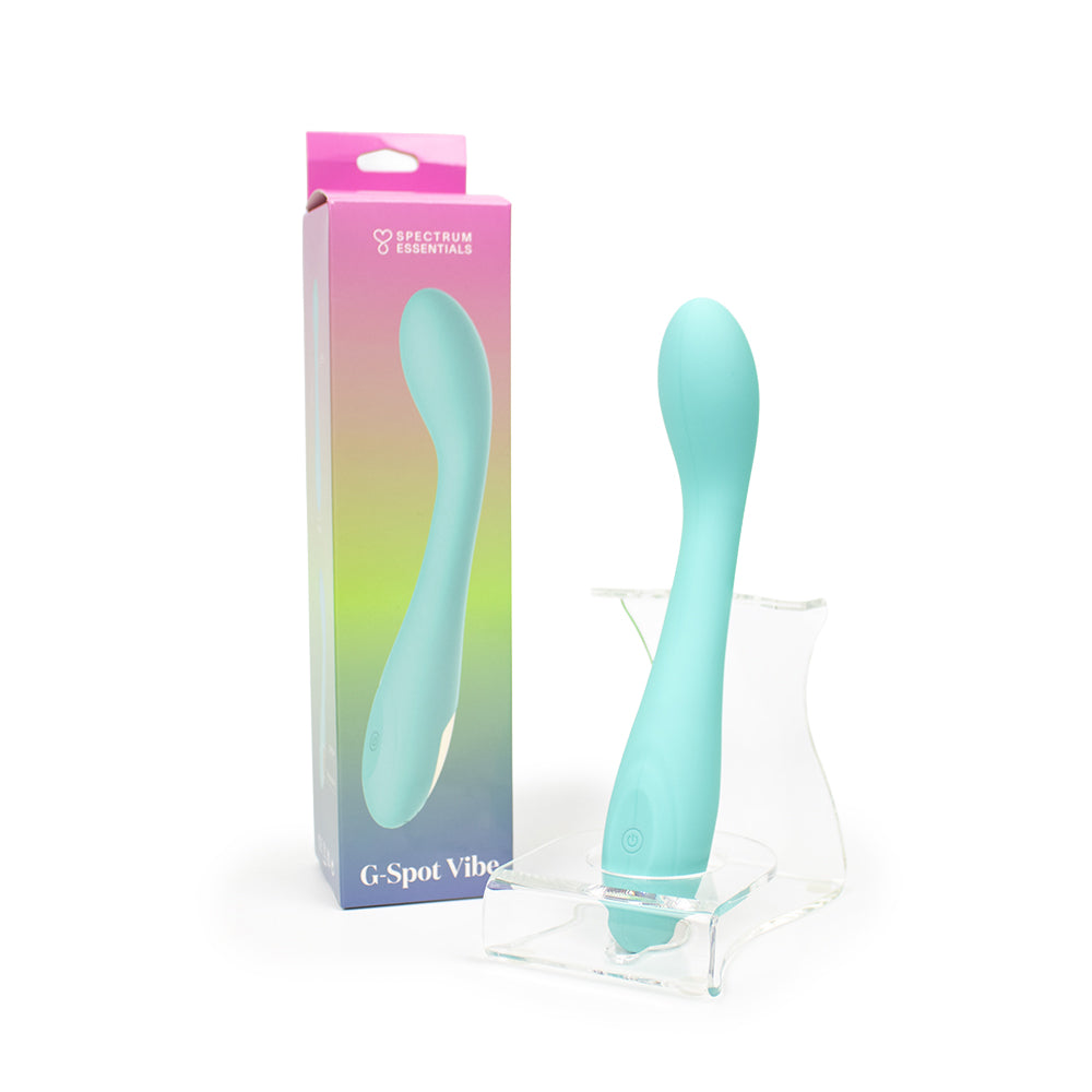 Spectrum Essentials Rechargeable Silicone G-Spot Vibrator Blue Aqua Spectrum Essentials curved vibrator beside gradient retail box