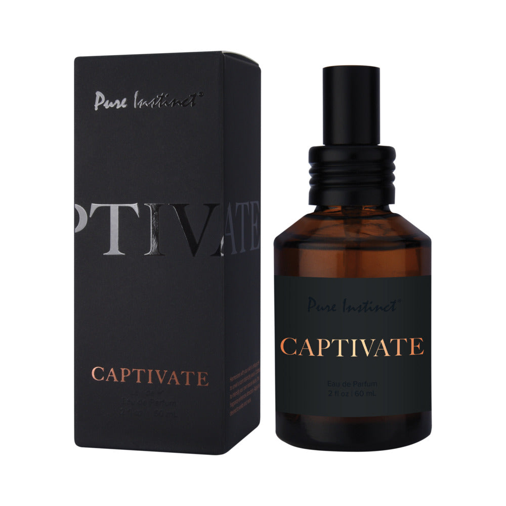 Pure Instinct Pheromone Eau De Parfum Captivate 2 Floz | 60 Ml Pure Instinct Captivate amber perfume spray bottle beside black box