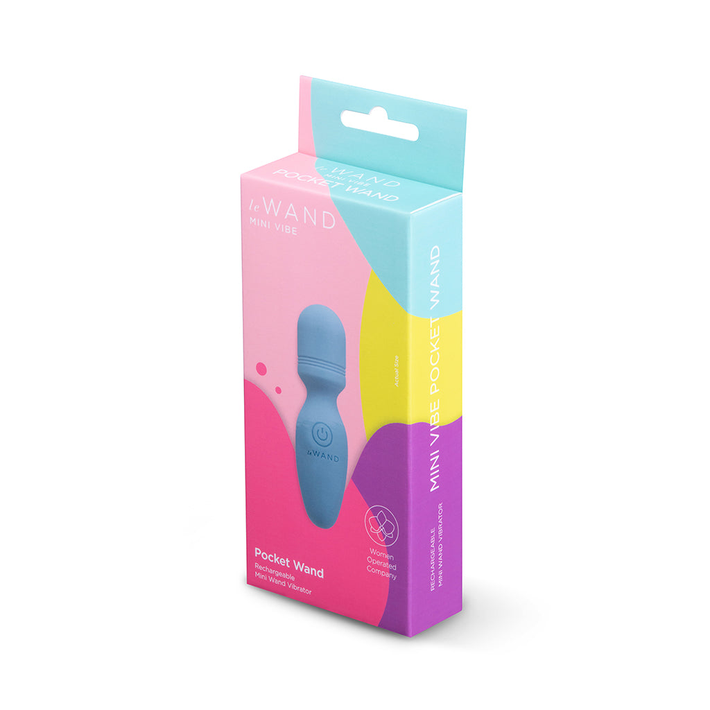 Le Wand Mini Vibe Pocket Wand Blue Le Wand Pocket Wand beside pink-and-teal retail box