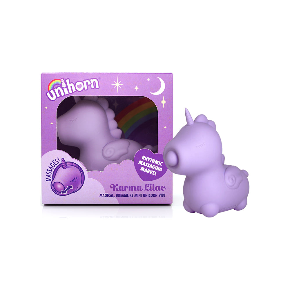 Unihorn Karma Lilac lilac Unihorn Karma unicorn vibrator with rainbow tail beside purple window box